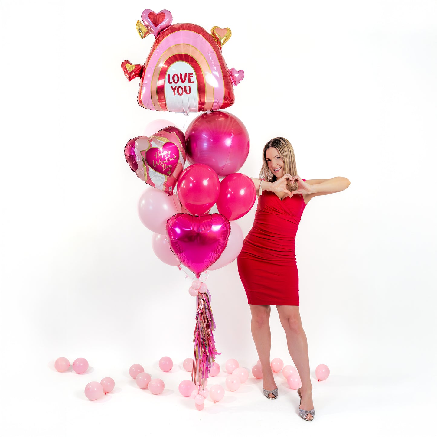 Detail of Valentines balloons Toronto showing the “Love You” rainbow heart foil balloon and Valentine heart foil balloons.