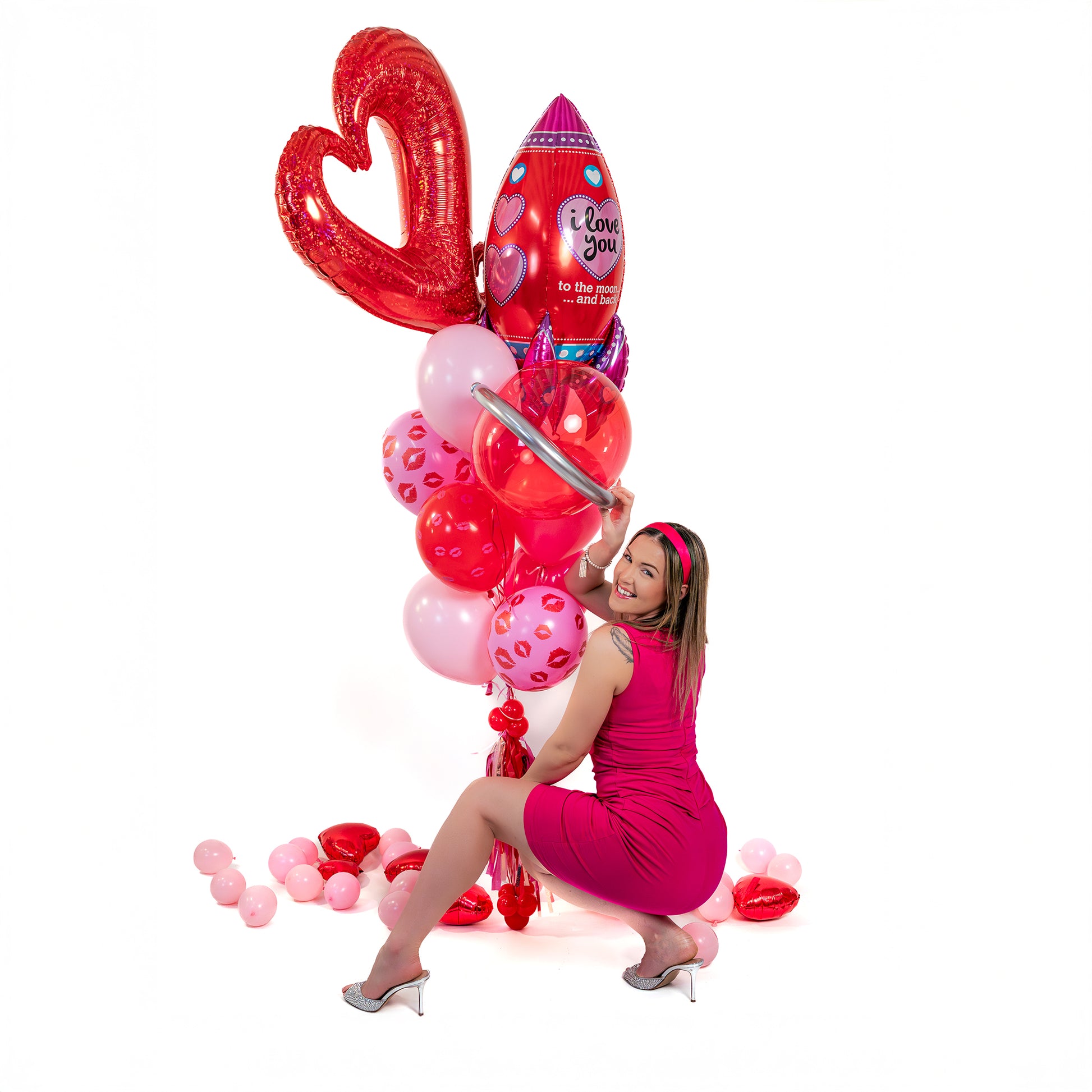 Valentines balloons Toronto bouquet styled for gifting, with red heart balloon, rocket balloon and tassel weight in a bright studio photo.