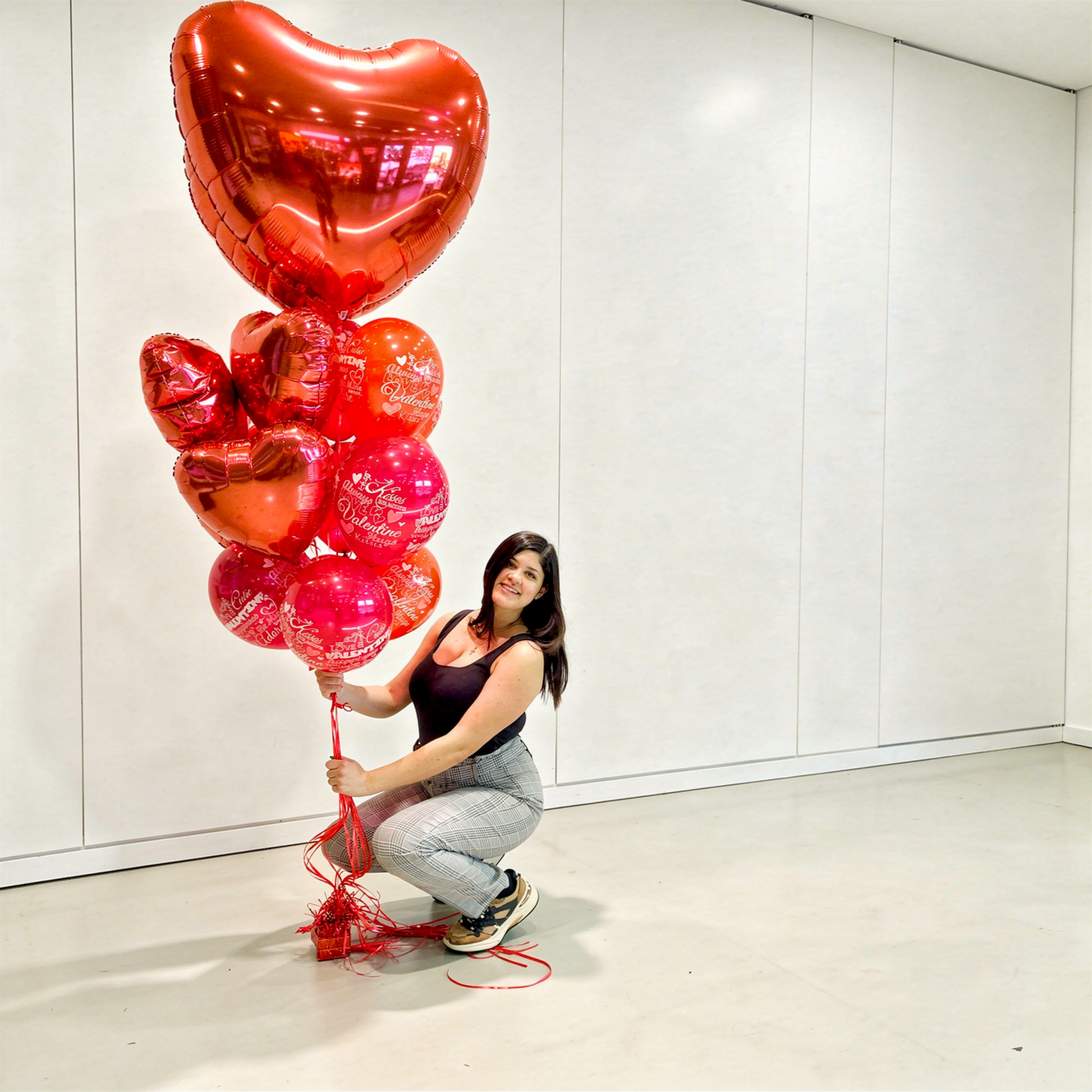 Valentine’s Day balloons Toronto lifestyle photo of a jumbo heart balloon bouquet with a large heart balloon and matching red balloon cluster