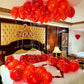 Valentine’s hotel room decoration with red balloons, roses, and warm lighting – romantic setup in Toronto