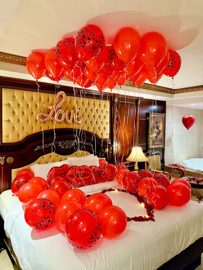Valentine’s hotel room decoration with red balloons, roses, and warm lighting – romantic setup in Toronto