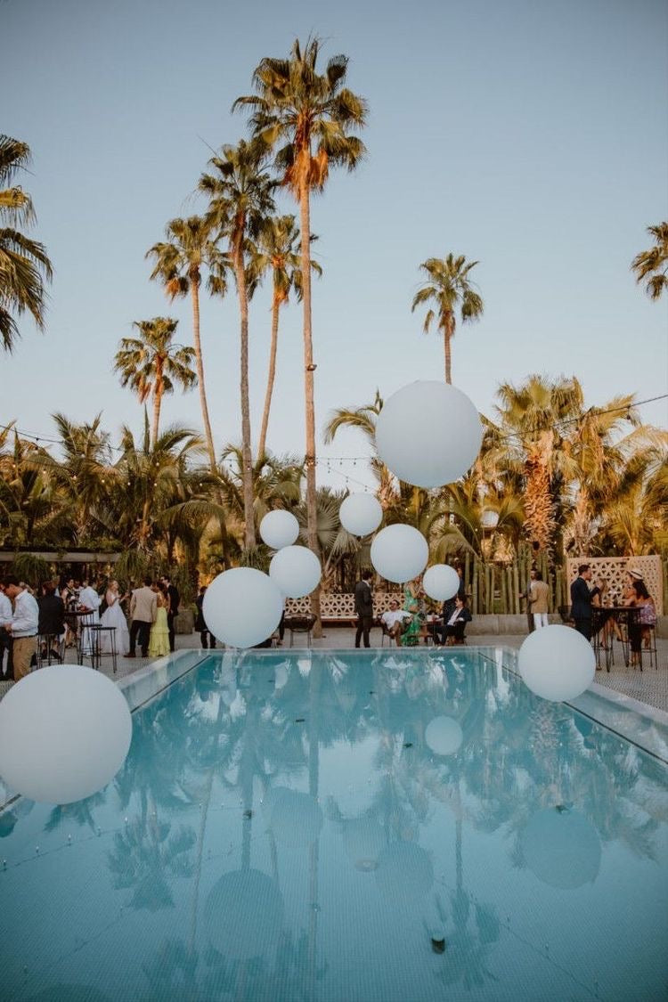 Helium-filled Pool Balloons in 17", 24", and 3ft sizes floating over a pool in Toronto