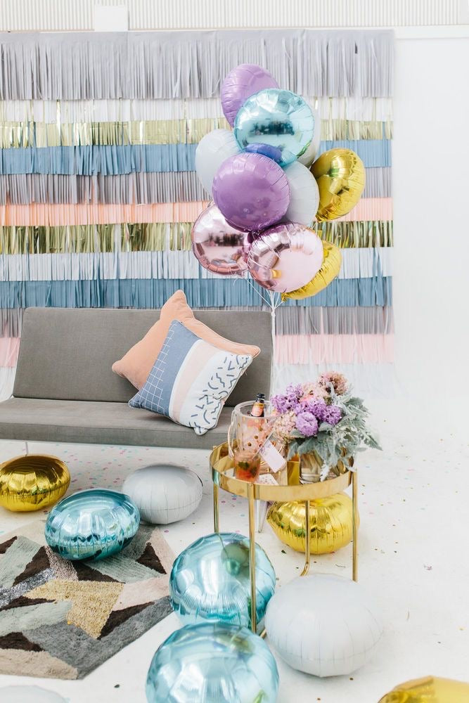 A colorful selection of 17" round foil balloons filled with helium