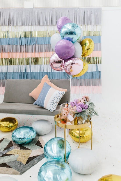 A colorful selection of 17" round foil balloons filled with helium