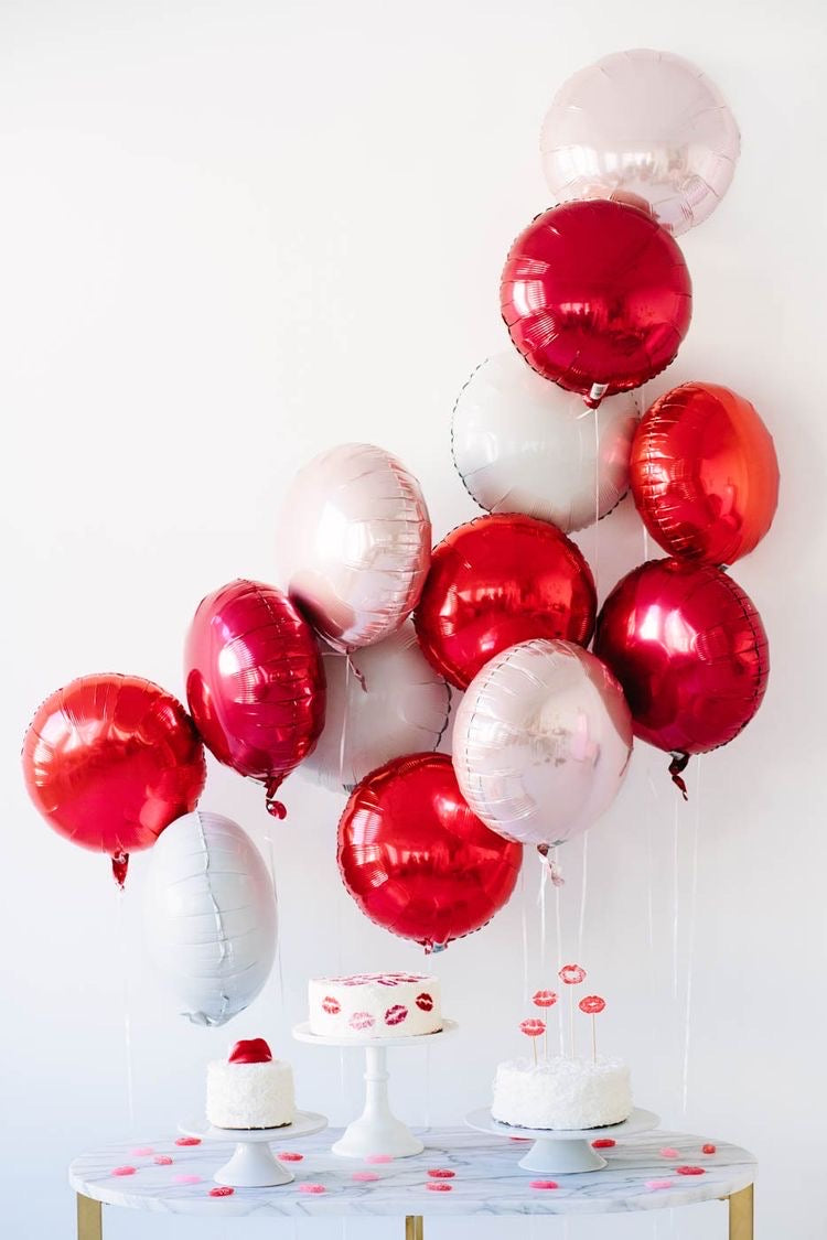 A colorful selection of 17" round foil balloons filled with helium