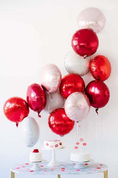 A colorful selection of 17" round foil balloons filled with helium
